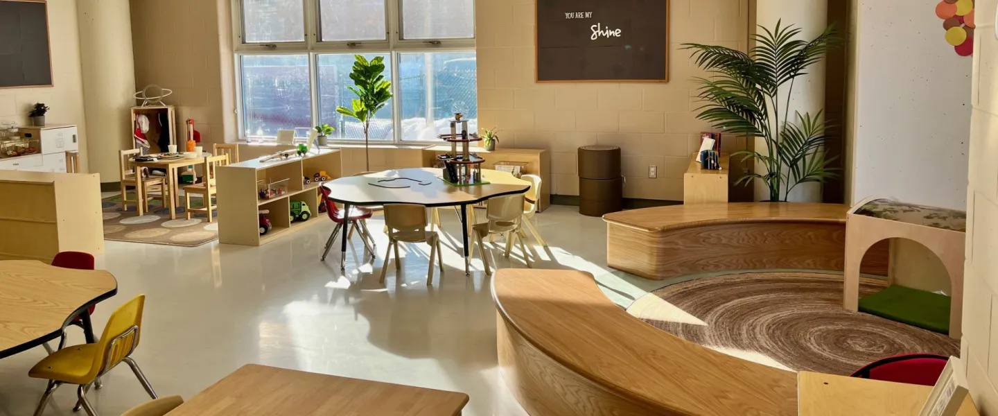 Churchill Child Care Centre interior. There are small chairs, tables, toys and decorations.