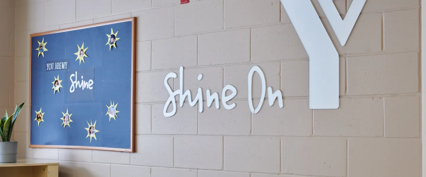 A wall in the Churchill Child Care Centre with a Y Shine On logo decal.