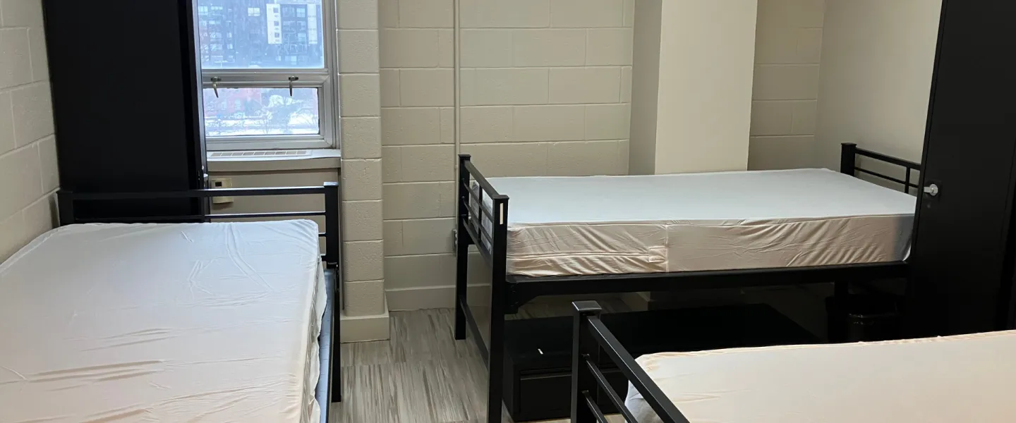 A bedroom with three twin beds