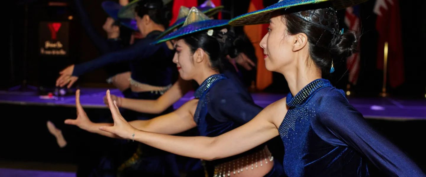 Dancers from the Huaxing Youth Dance Group performing a routine in navy blue attire