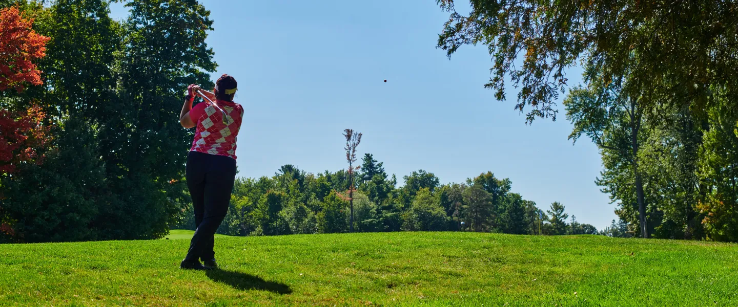 A golfer swinging a golf club on a golf course