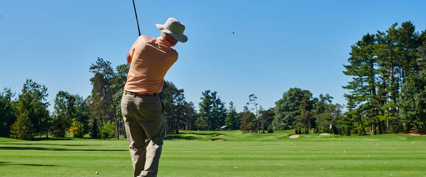A golfer swinging a golf club on a golf course