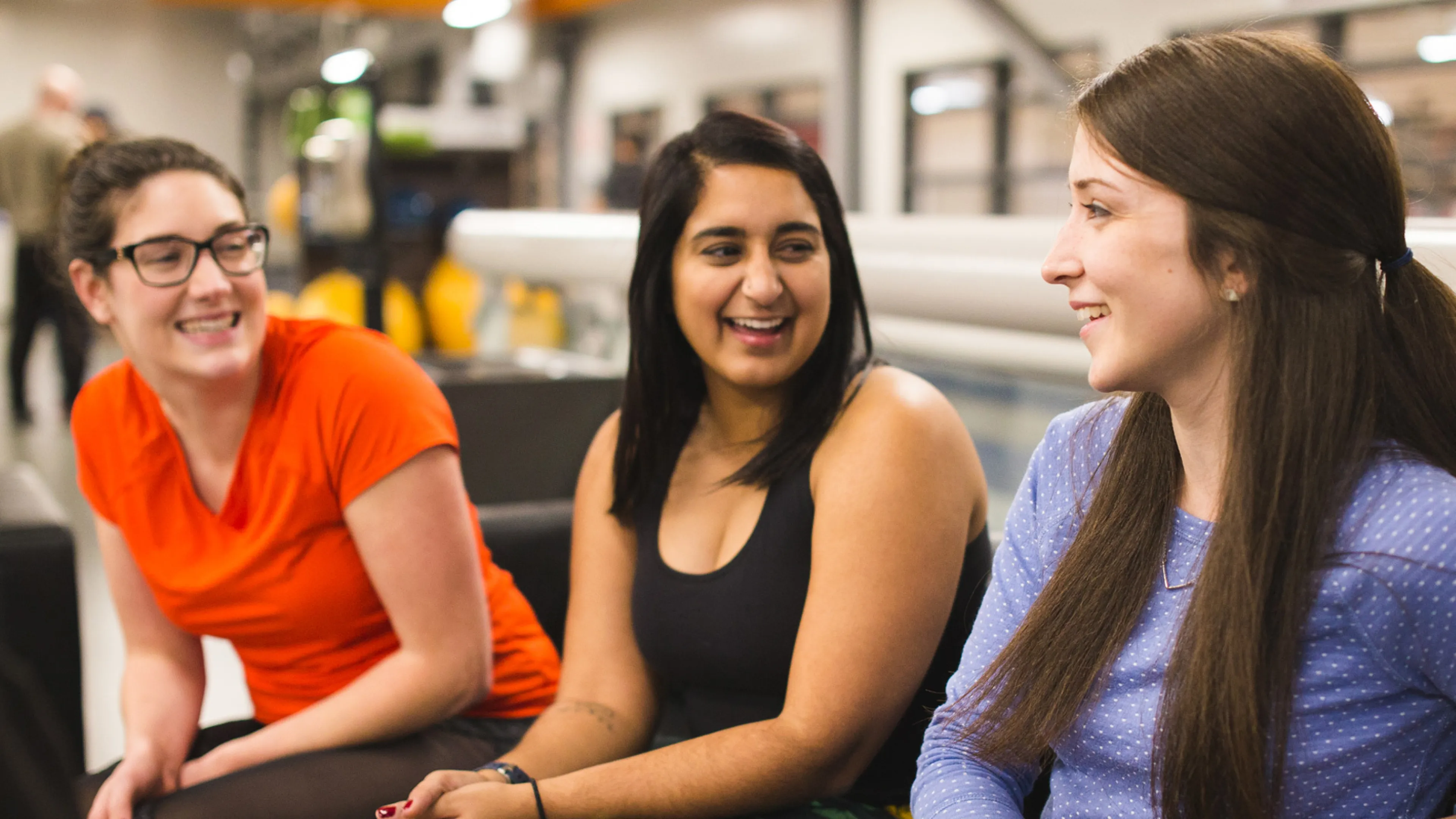 Three woman sitting together having a conversation.