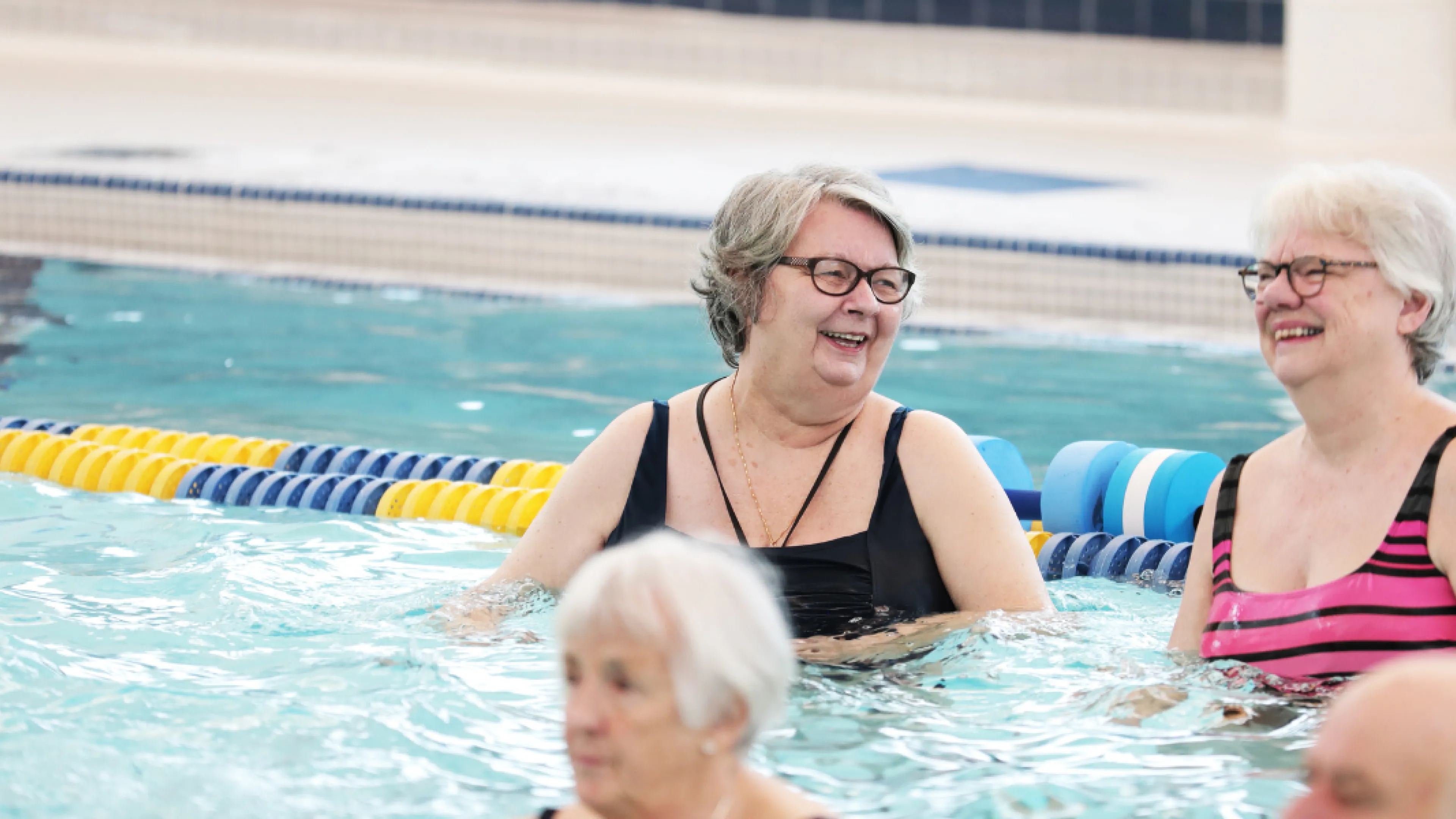 A group of seniors enjoy the pool.