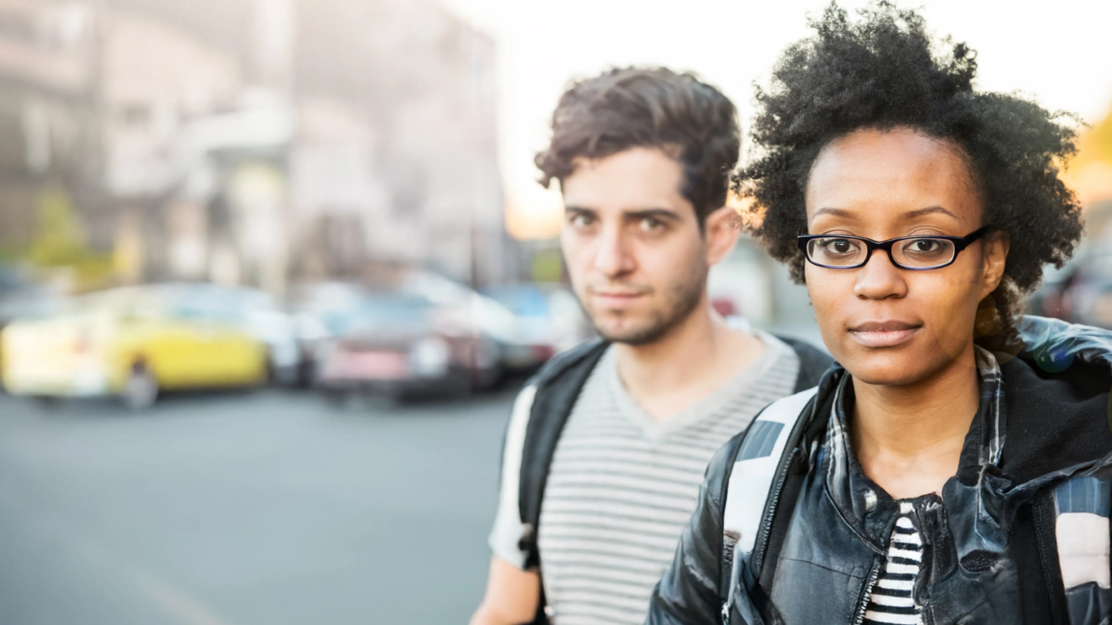 Man and woman outdoors on street.