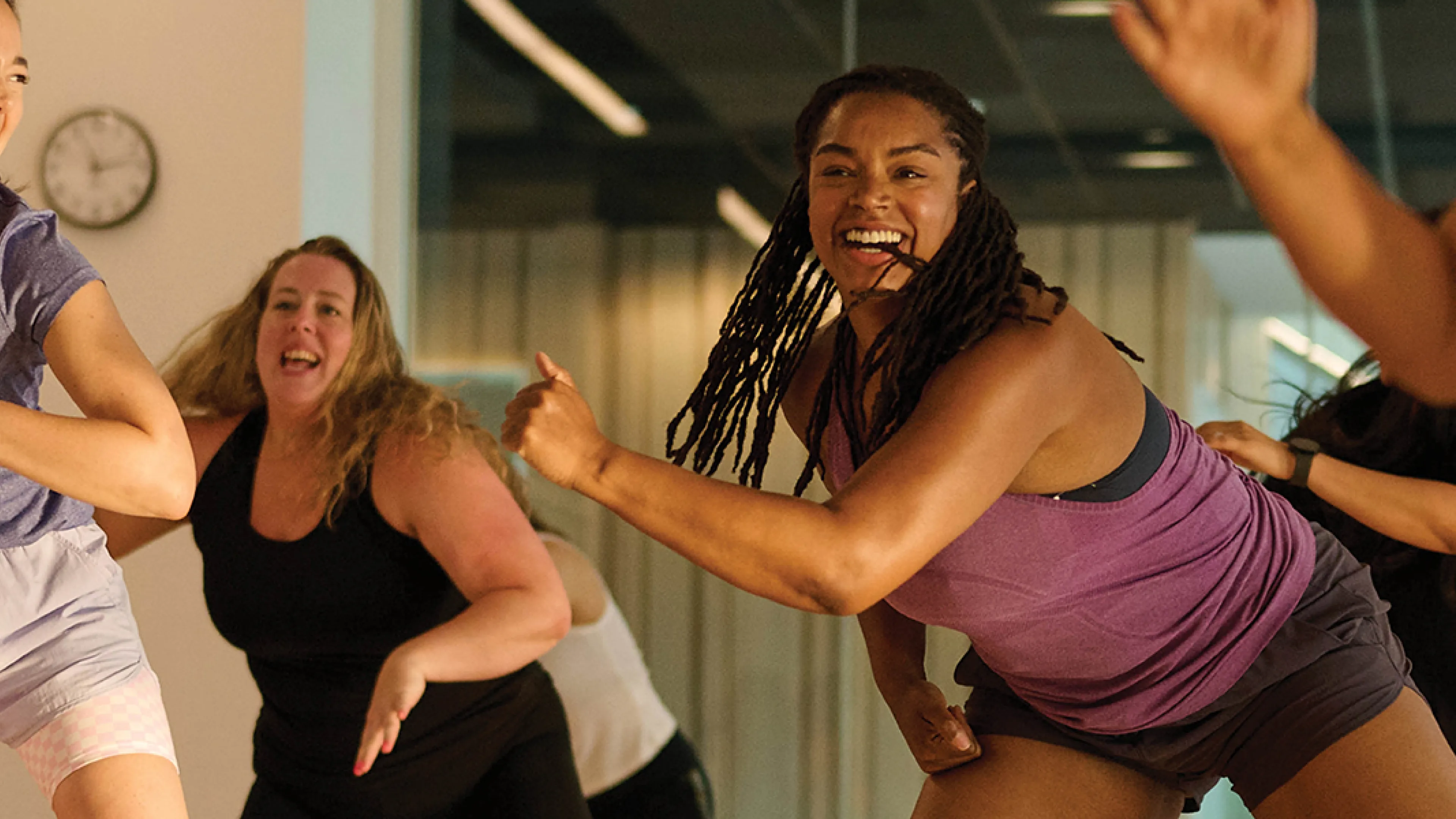 Several women engaged in a dance class, demonstrating different movements and enjoying the rhythm together.