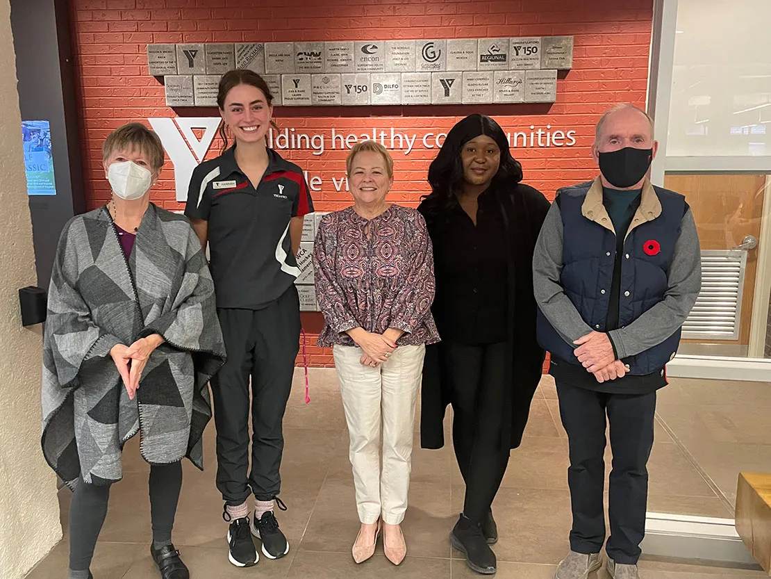 Three Y staff with bursary winners Hannah Scaletta and Sophia Desir