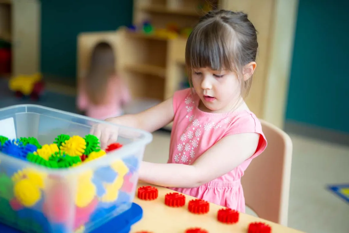 Young girl plays with blocks.